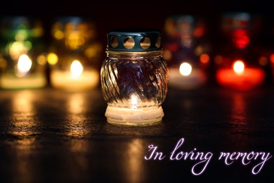 Image of In loving memory. Many different grave lights on table in darkness