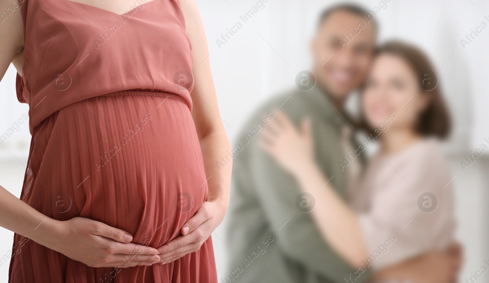Surrogate mother and intended parents indoors, selective focus Image of Surrogate mother and intended parents indoors, selective focus