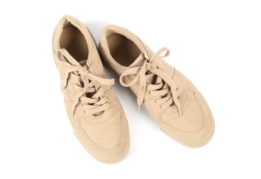 Photo of Pair of stylish beige sneakers on white background, top view