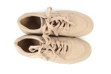 Photo of Pair of stylish beige sneakers on white background, top view