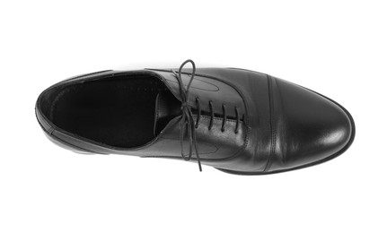 Photo of One black leather shoe on white background, top view
