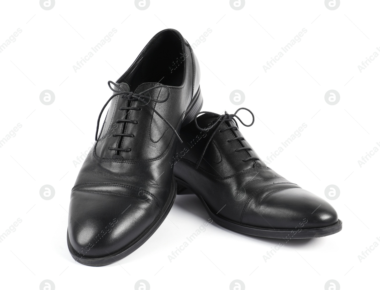 Photo of Pair of black leather shoes on white background
