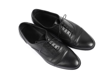 Photo of Pair of black leather shoes on white background, top view