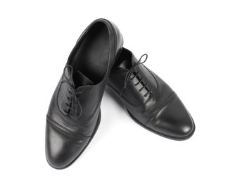 Photo of Pair of black leather shoes on white background, top view