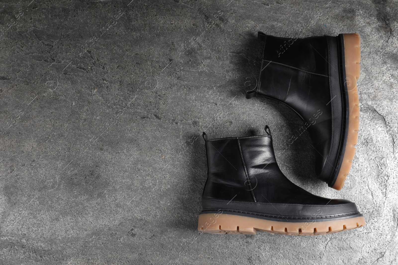 Photo of Pair of stylish black boots on grey surface, flat lay. Space for text