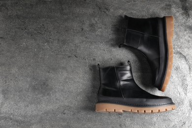 Photo of Pair of stylish black boots on grey surface, flat lay. Space for text