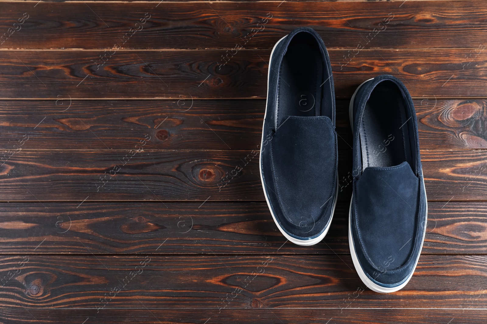 Photo of Pair of dark blue shoes on wooden surface, flat lay. Space for text
