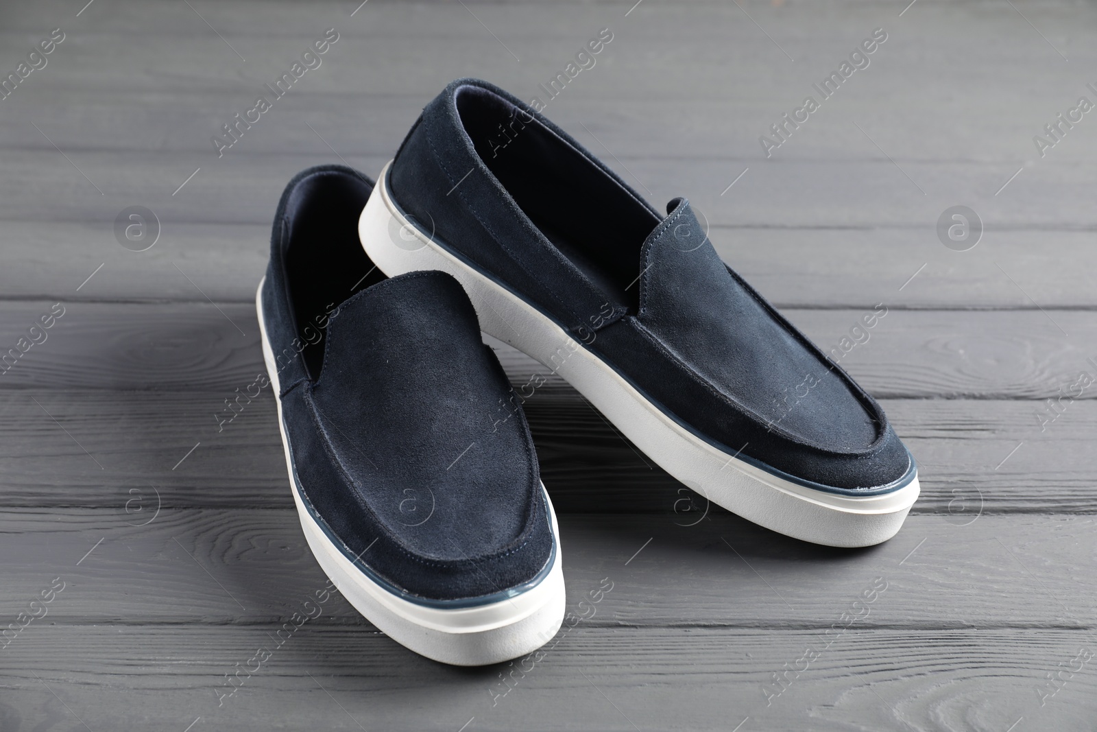 Pair of dark blue shoes on grey wooden surface, closeup Photo of Pair of dark blue shoes on grey wooden surface, closeup