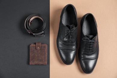 Photo of Pair of black leather shoes, purse and belt on color background, flat lay