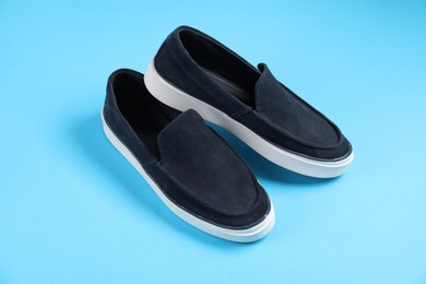 Photo of Pair of shoes on light blue background