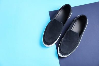 Photo of Pair of dark blue shoes on color background, flat lay. Space for text