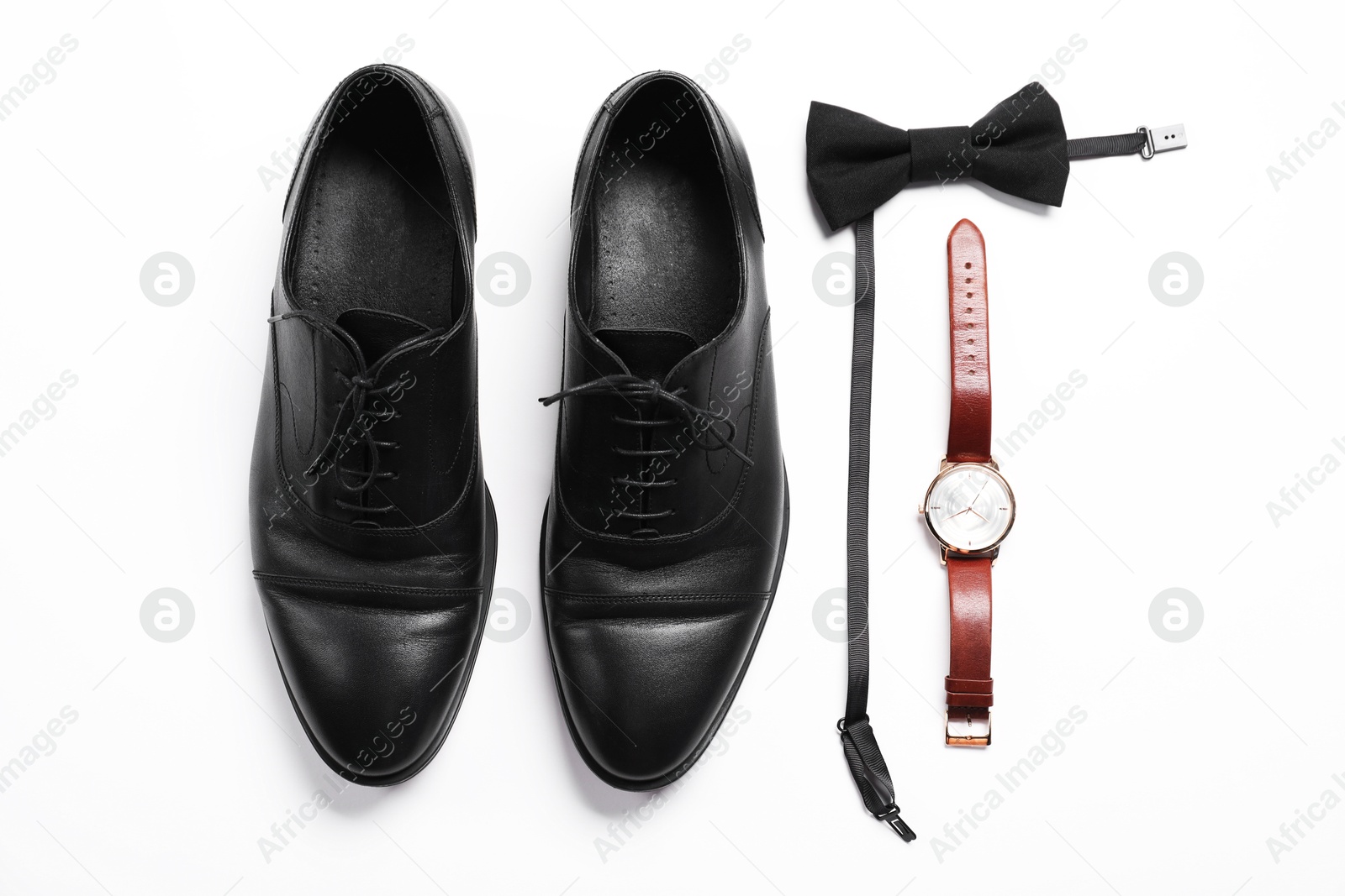 Pair of black leather shoes, bow tie and wrist watch on white background, flat lay Photo of Pair of black leather shoes, bow tie and wrist watch on white background, flat lay