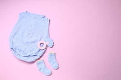 Photo of Baby clothes and accessory on pink background, flat lay. Space for text