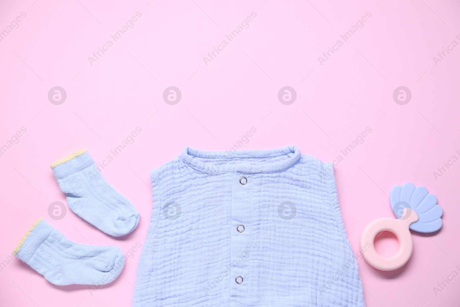 Baby clothes and accessory on pink background, flat lay. Space for text Photo of Baby clothes and accessory on pink background, flat lay. Space for text