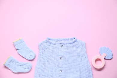 Photo of Baby clothes and accessory on pink background, flat lay. Space for text