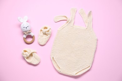 Photo of Baby clothes and accessory on pink background, flat lay