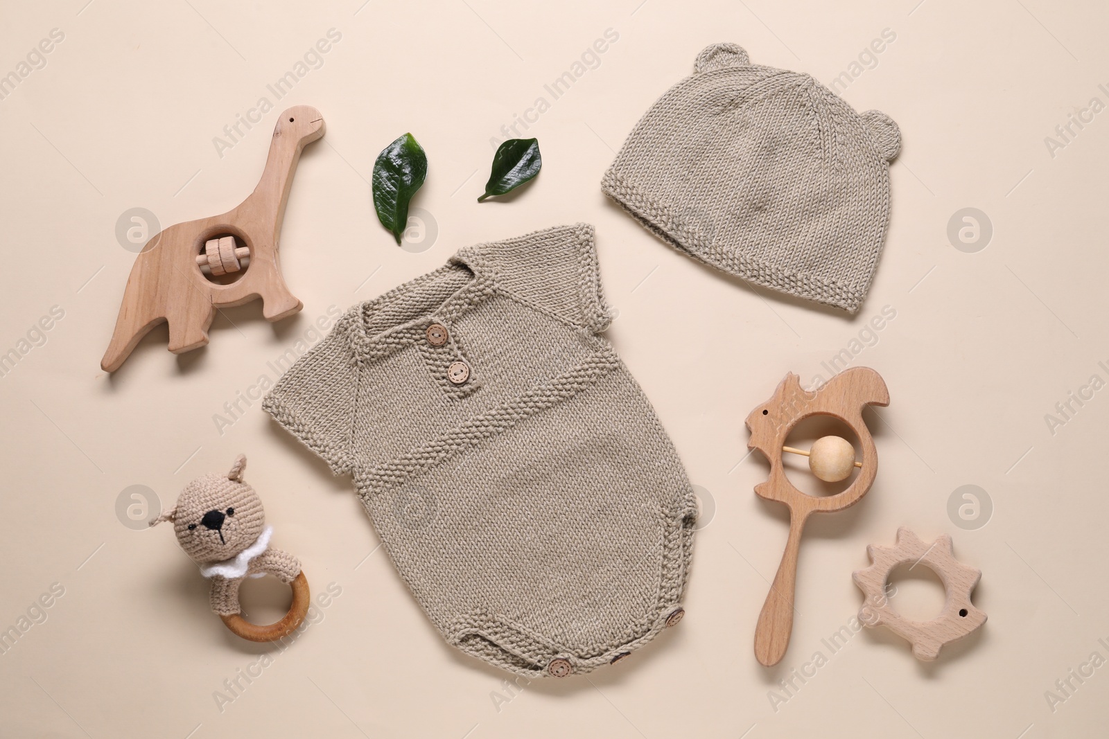 Photo of Baby clothes and accessories on beige background, flat lay