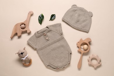 Photo of Baby clothes and accessories on beige background, flat lay