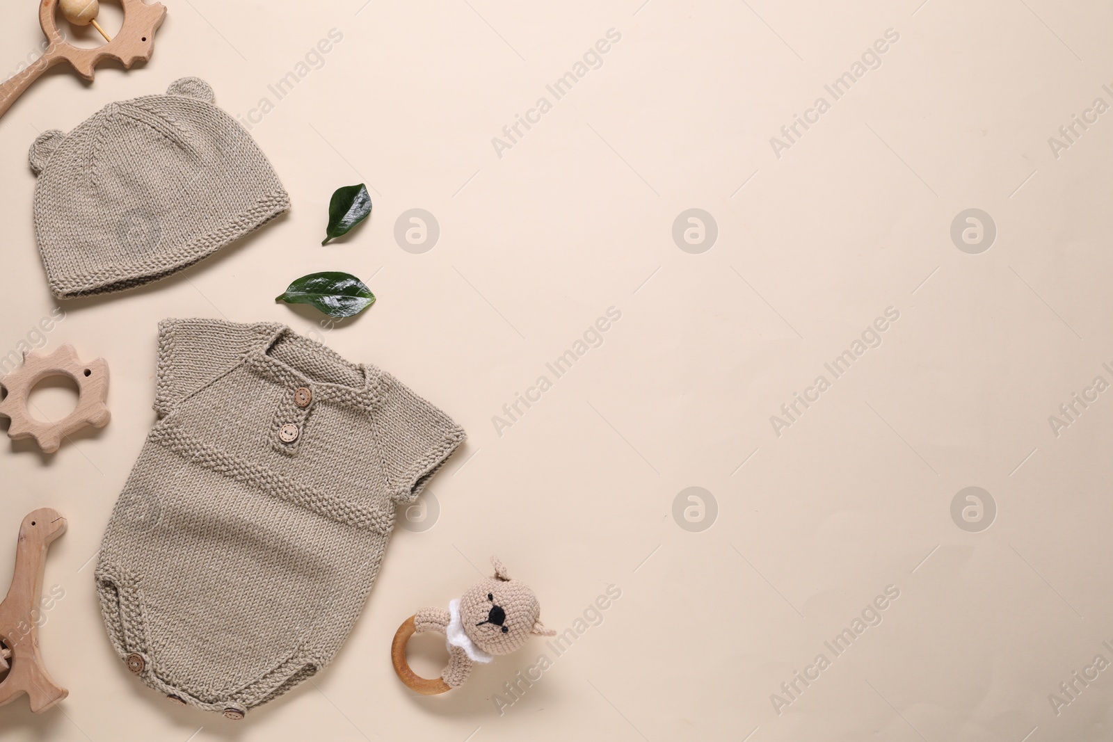 Photo of Baby clothes and accessories on beige background, flat lay. Space for text