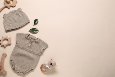 Photo of Baby clothes and accessories on beige background, flat lay. Space for text