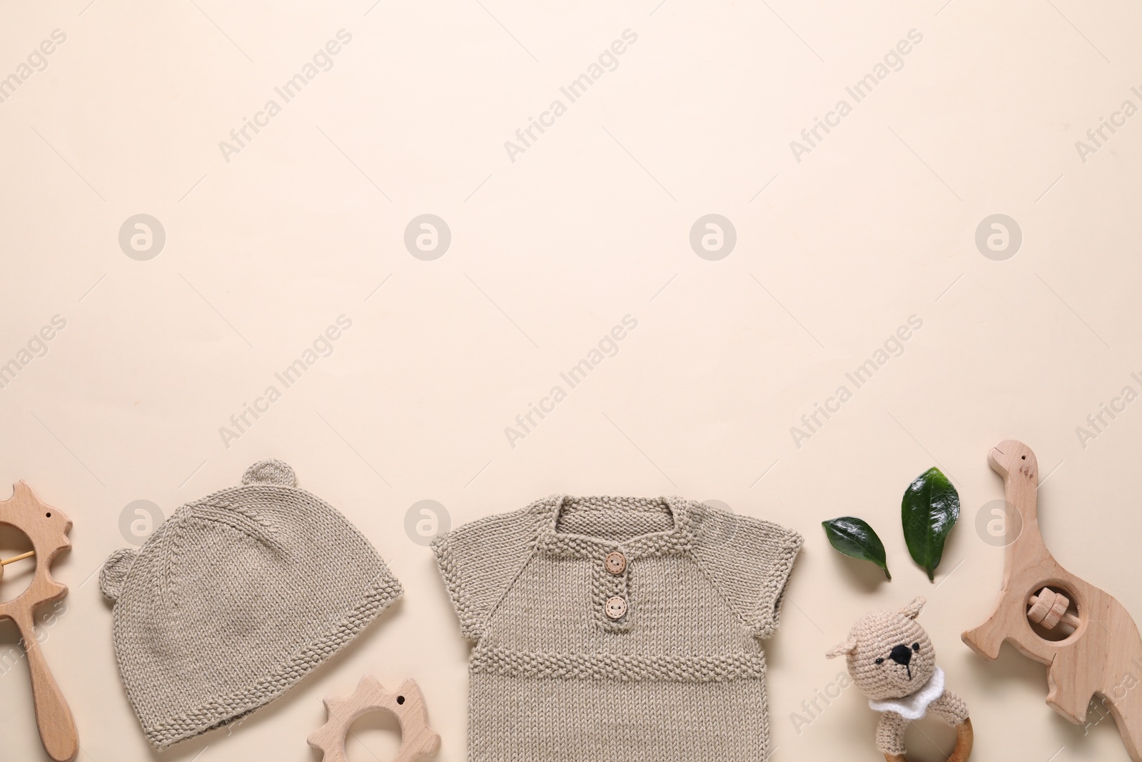 Photo of Baby clothes and accessories on beige background, flat lay. Space for text