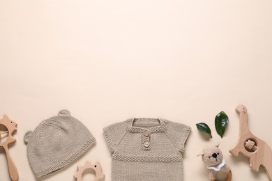 Photo of Baby clothes and accessories on beige background, flat lay. Space for text