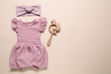 Photo of Baby clothes and accessories on beige background, flat lay. Space for text