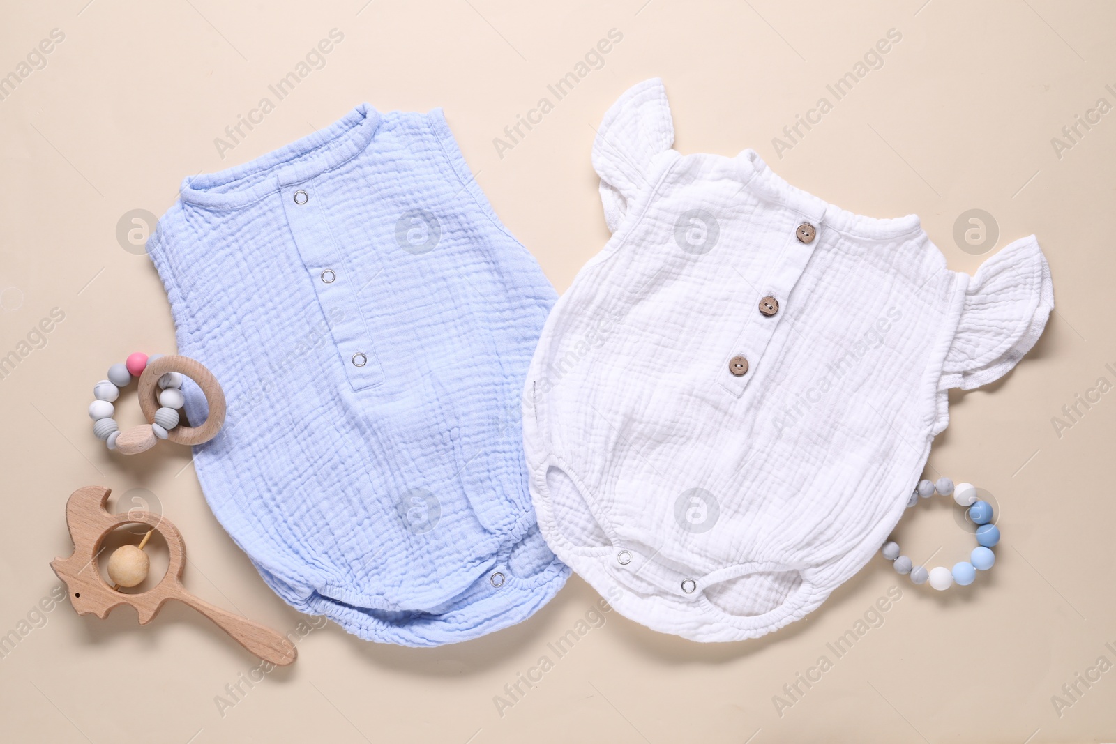 Baby clothes and accessories on beige background, flat lay Photo of Baby clothes and accessories on beige background, flat lay