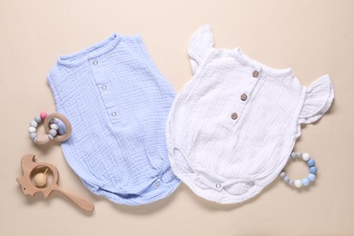 Photo of Baby clothes and accessories on beige background, flat lay