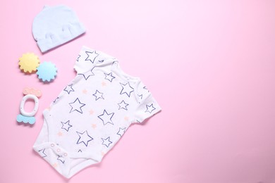 Photo of Baby clothes and accessories on pink background, flat lay. Space for text