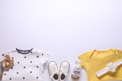 Photo of Baby clothes and accessories on white background, flat lay. Space for text