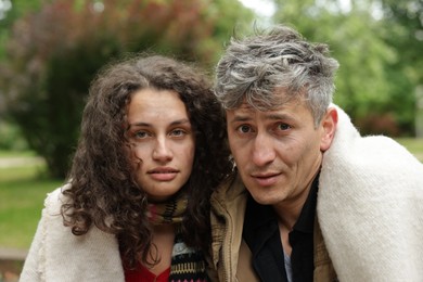 Photo of Portrait of poor homeless people in park