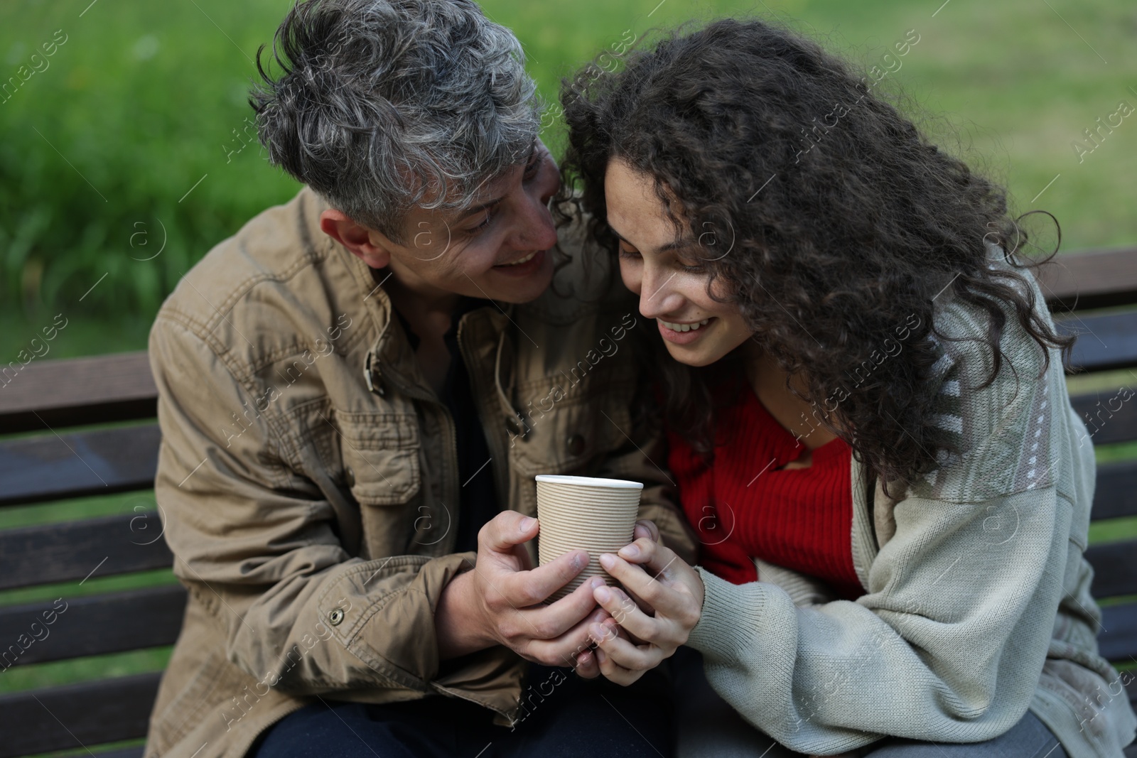 Homeless people with paper cup on bench in park Photo of Homeless people with paper cup on bench in park