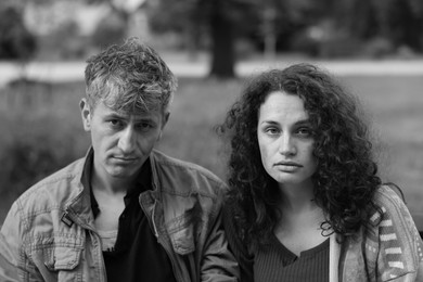 Photo of Portrait of homeless people outdoors. Black and white effect