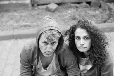 Photo of Portrait of homeless people outdoors. Black and white effect
