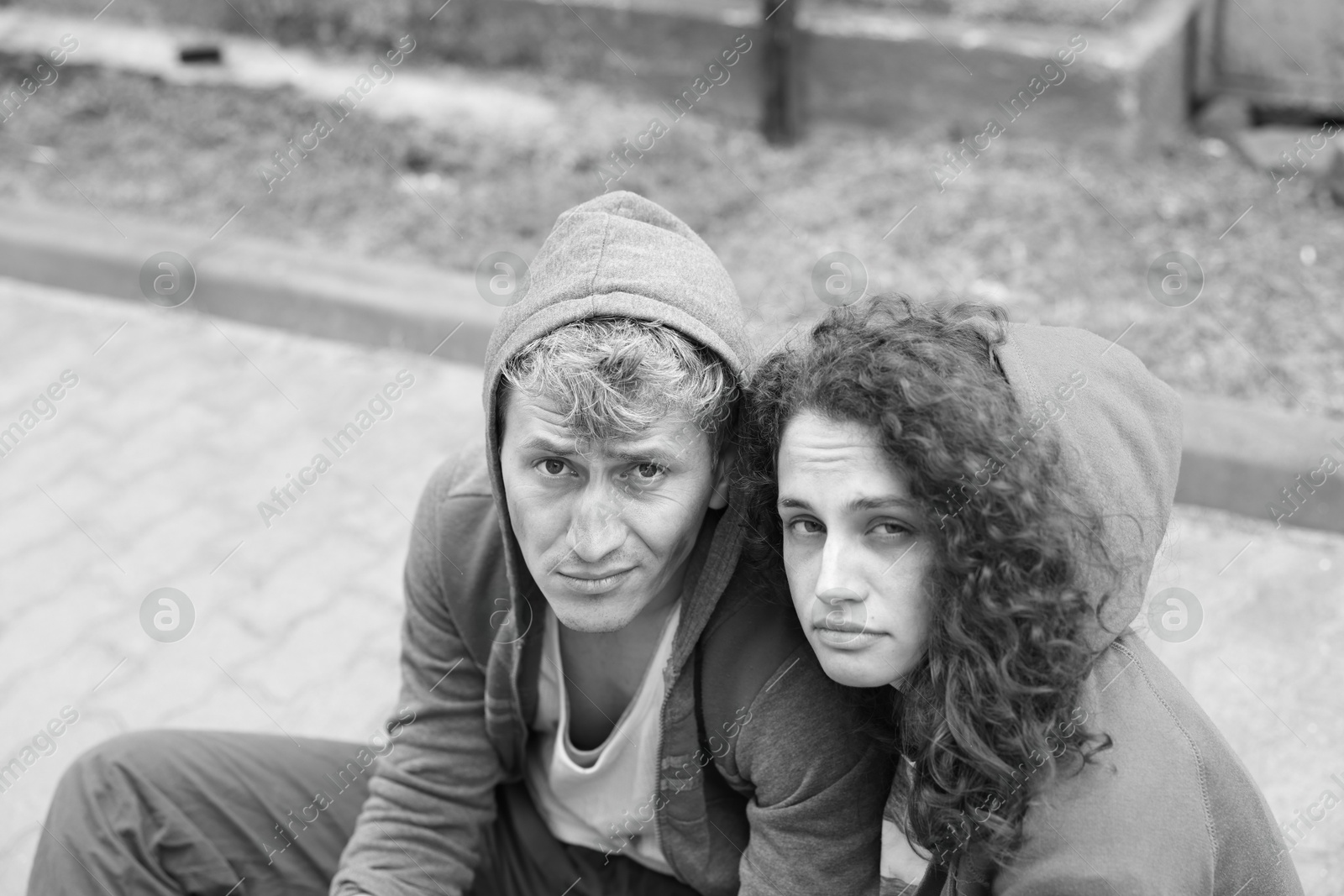Photo of Portrait of homeless people outdoors. Black and white effect