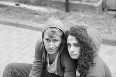 Photo of Portrait of homeless people outdoors. Black and white effect