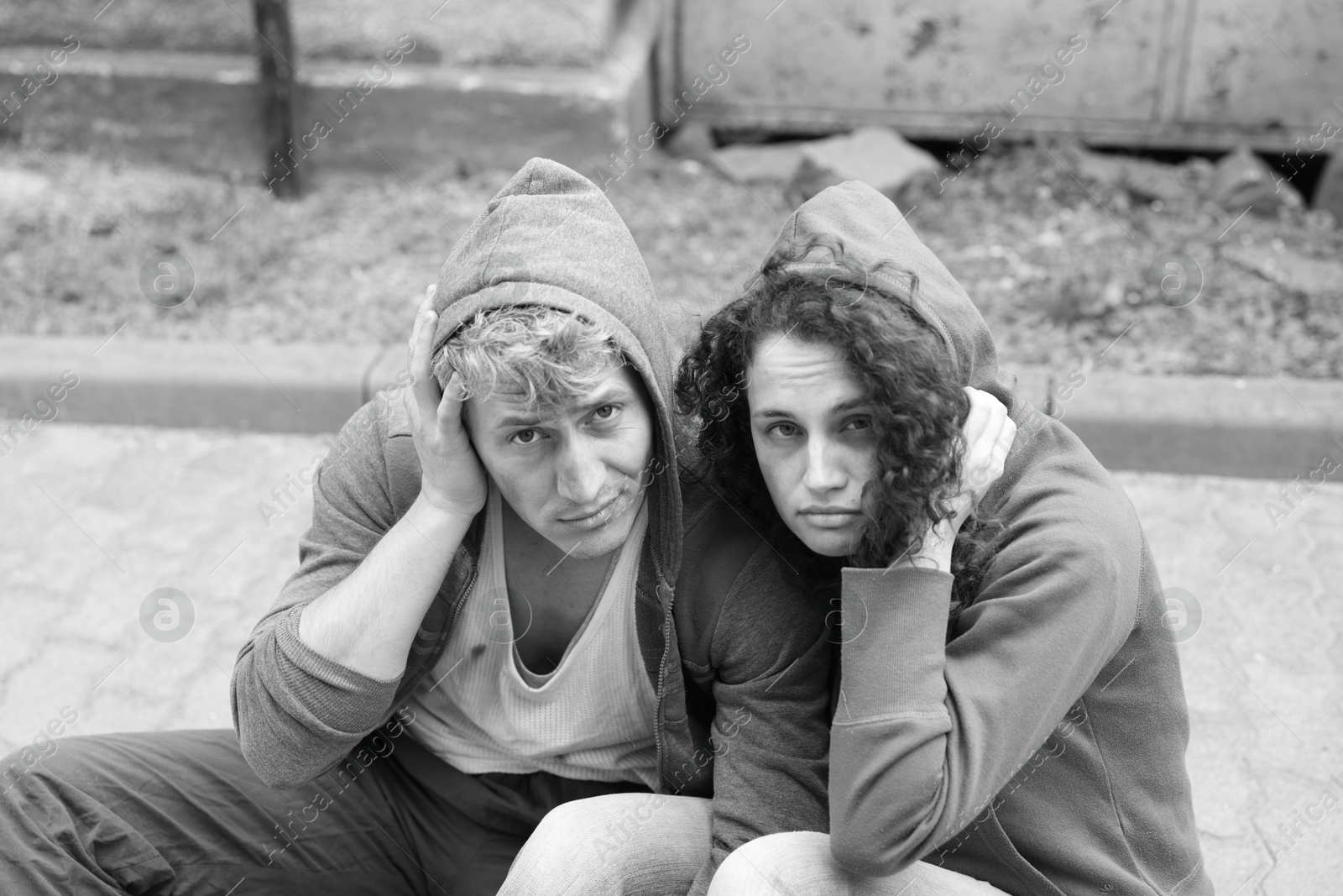 Photo of Portrait of homeless people outdoors. Black and white effect