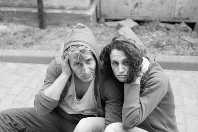 Photo of Portrait of homeless people outdoors. Black and white effect
