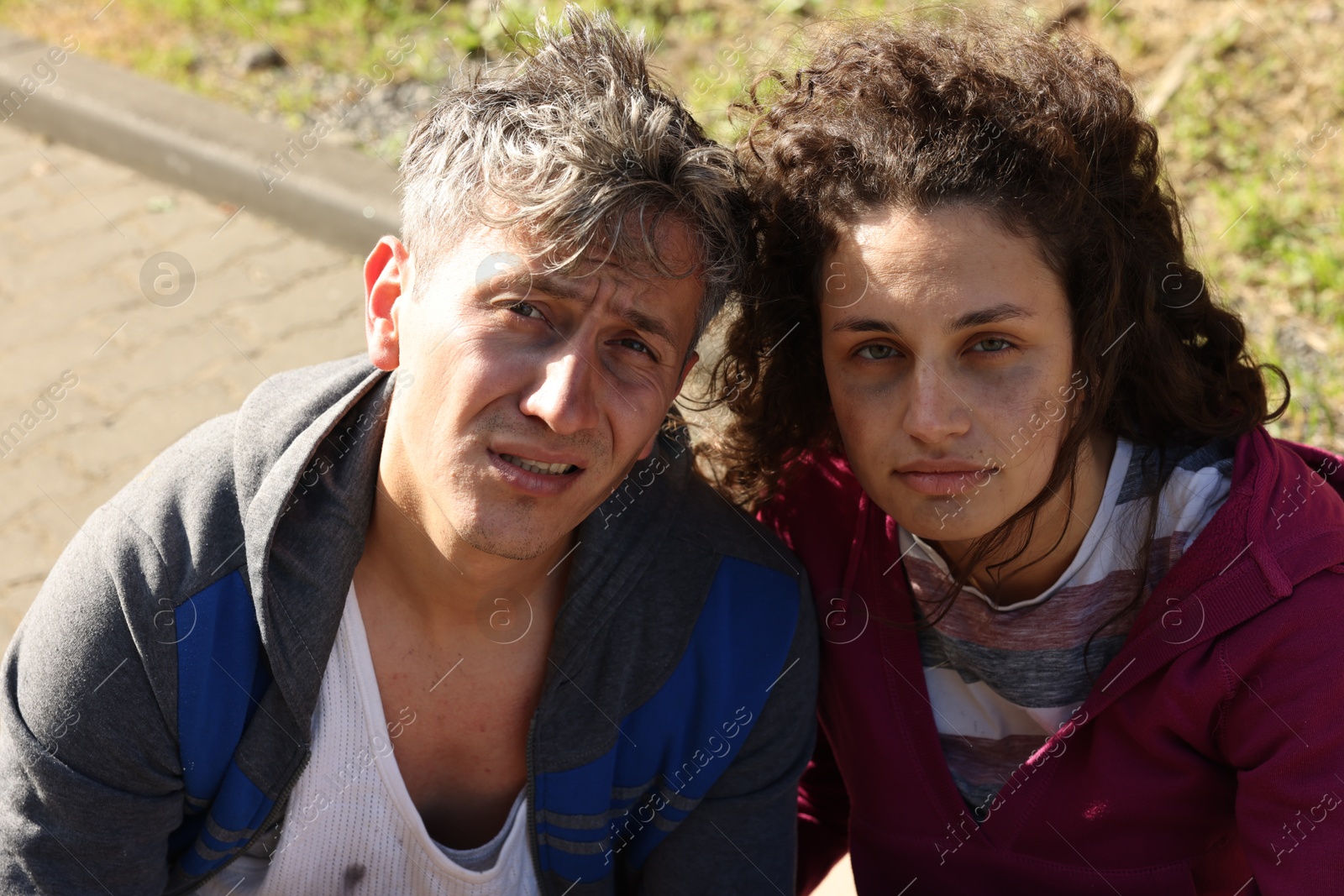 Photo of Portrait of poor homeless people on city street