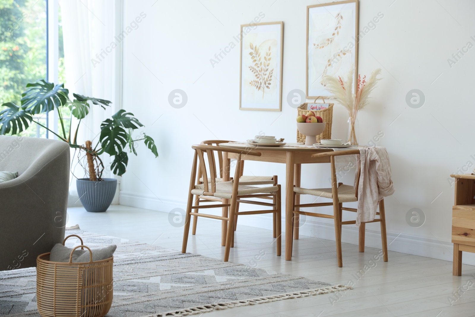 Photo of Beautiful table setting, chairs and decor in dining room. Interior design