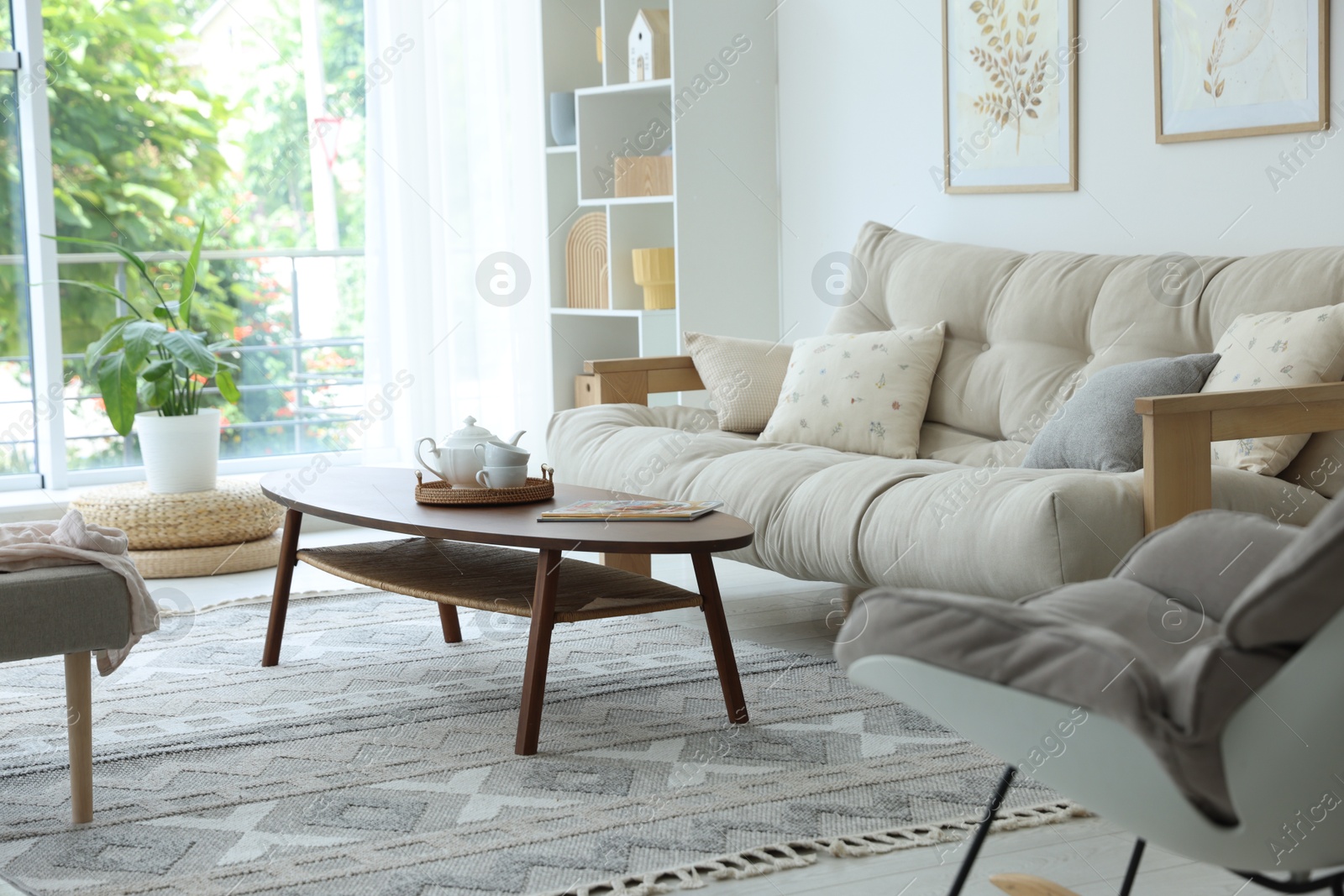 Photo of Coffee table, sofa and decor in dining room. Interior design