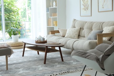 Photo of Coffee table, sofa and decor in dining room. Interior design