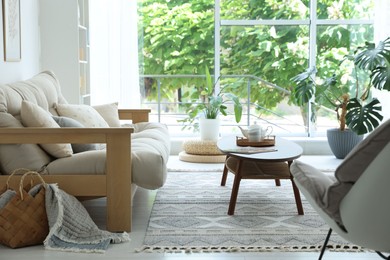 Photo of Coffee table, sofa and decor in dining room. Interior design