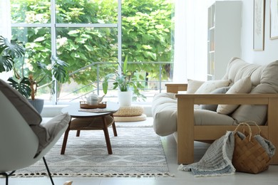 Photo of Coffee table, sofa and decor in dining room. Interior design