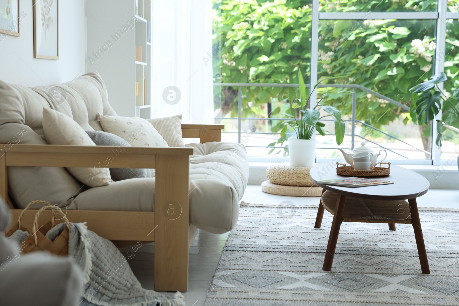 Photo of Coffee table, sofa and decor in dining room. Interior design