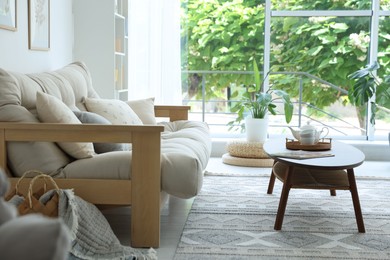 Photo of Coffee table, sofa and decor in dining room. Interior design