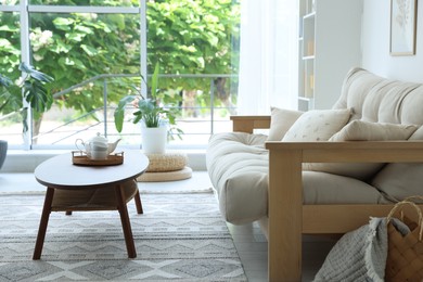 Photo of Coffee table, sofa and decor in dining room. Interior design
