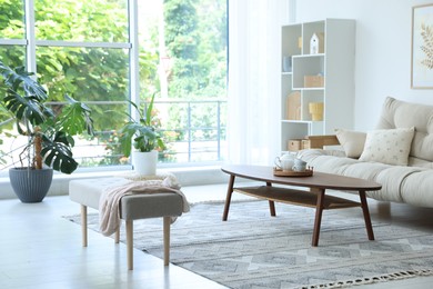 Photo of Coffee table, sofa and decor in dining room. Interior design