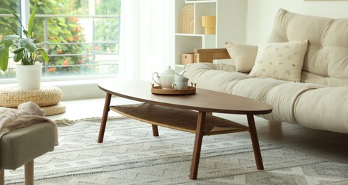 Photo of Coffee table, sofa and decor in dining room. Interior design